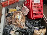 many bags of food in a plastic container on the street