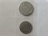 two coins sitting on top of each other on a table