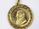 a close up of a gold coin with a chain around it
