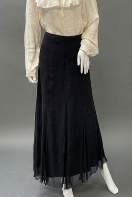 a white blouse and black skirt with ruffles on a mannequin mannequin mannequin mannequin mannequin mannequin manne