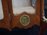 a wooden cabinet with a brass plate on the door