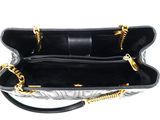 a black and white handbag with a gold chain strap