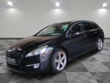 the black car is parked on a checkered floor in the garage