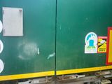 a green and yellow train with stickers on the side of it