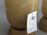 two vases with tags on them sitting on a table