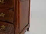 a small wooden chest of drawers with gold handles