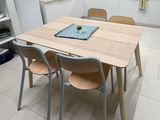 four chairs around a table in a small kitchen
