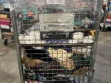 a cage with a bunch of items inside of it