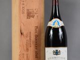 a bottle of wine sitting next to a wooden box