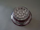 a glass jar with a silver lid sitting on a table