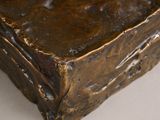 a bronze statue of a book sitting on a table