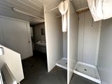 a bathroom with a shower and a sink in it