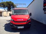 a red van that is parked in a parking lot