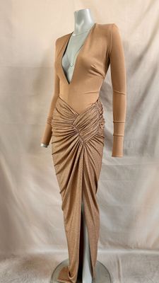 an image of a mannequin wearing a tan dress on a mannequin stand