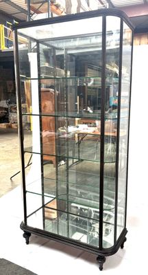 a glass display case with a clock inside of it