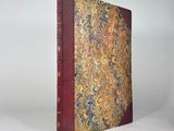 an old book with a red cover and a gold and blue design