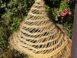 a straw hat sitting on top of a pile of mulch