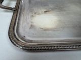 a silver tray that has a handle on it