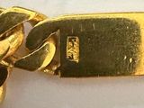 a gold plated bracelet with a chain attached to it
