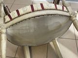 a white chair with a red and white seat on it