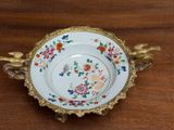 a plate with flowers on it sitting on a wooden table