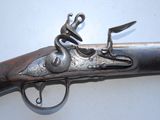 an old gun that is on display on a table