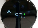 a digital clock that is on the side of a table