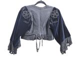 the back of a blue jacket with fringes on a hanger