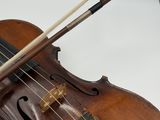 a violin that is sitting on a table next to a clock