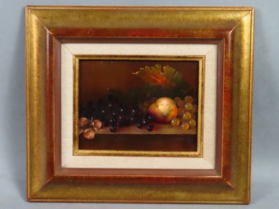 tableau représentant une nature morte composée de fruits et de noix, dans un cadre doré