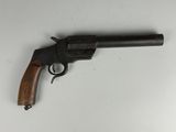 an old revolver with a wooden handle on a white surface