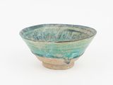 a small bowl that is sitting on a white surface