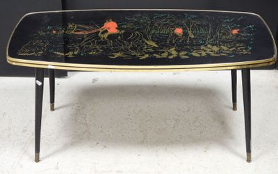 an image of a black and gold coffee table with flowers on it