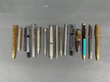 a lot of pens that are lined up on the table