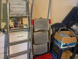 a stack of luggage next to a ladder in a room