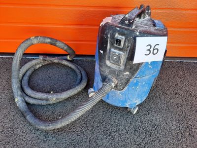 a blue machine that has a hose attached to it