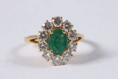 an oval emerald and diamond cluster ring
