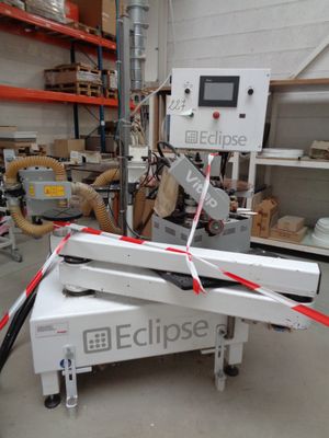 a machine that is cutting a piece of paper in a factory