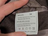 a person that is holding a jacket with a label on it