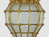 a gold hanging light with a crown on it