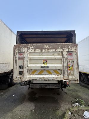 two trucks that are parked next to each other on the street