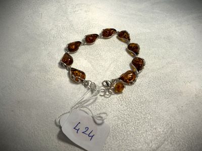 a close up of a bracelet with a tag attached to it