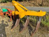 a yellow plow that is sitting on the side of the road