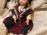 a doll that is laying on a bed with a pillow