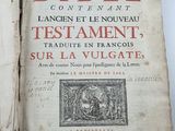 an old book with writing on it sitting on a table