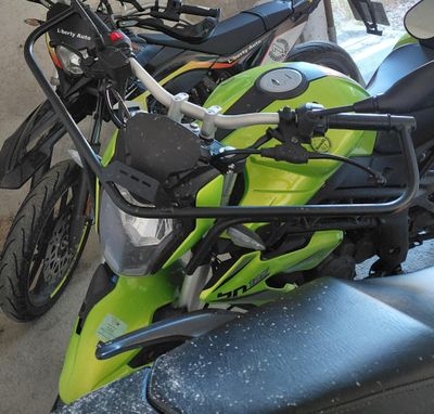 many motorcycles parked next to each other in a parking lot