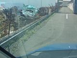 a car driving down the road in front of a building
