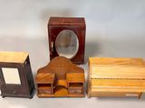 three small wooden boxes and a clock on a table