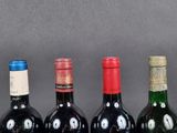 several bottles of wine are lined up on a table