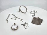 a white table with a bunch of silver items on it